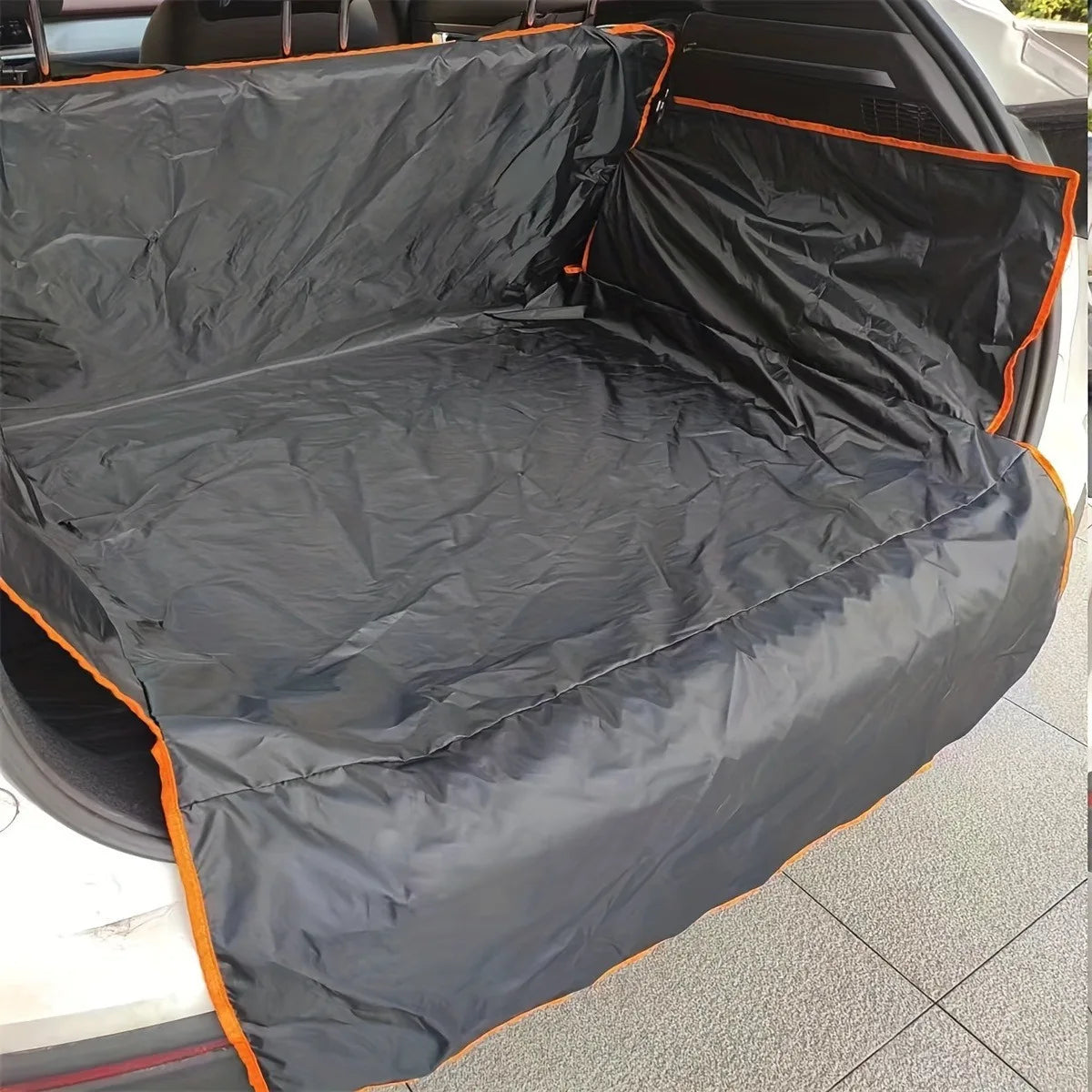 Black dog car seat cover with orange trim, protecting rear seats for all-weather pet travel